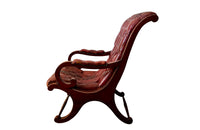 20th Century mahogany Regency Revival armchair with worn red buttoned leather.