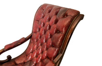 20th Century mahogany Regency Revival armchair with worn red buttoned leather.