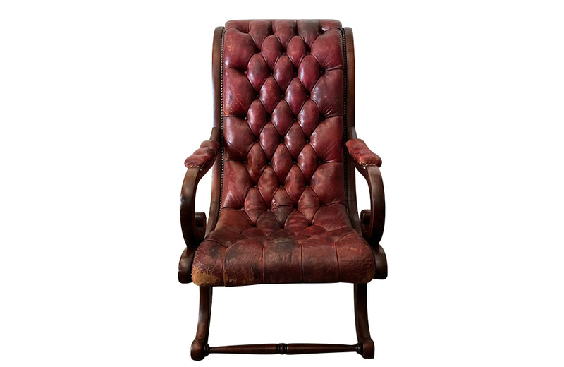 20th Century mahogany Regency Revival armchair with worn red buttoned leather.