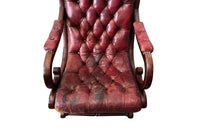 20th Century mahogany Regency Revival armchair with worn red buttoned leather.