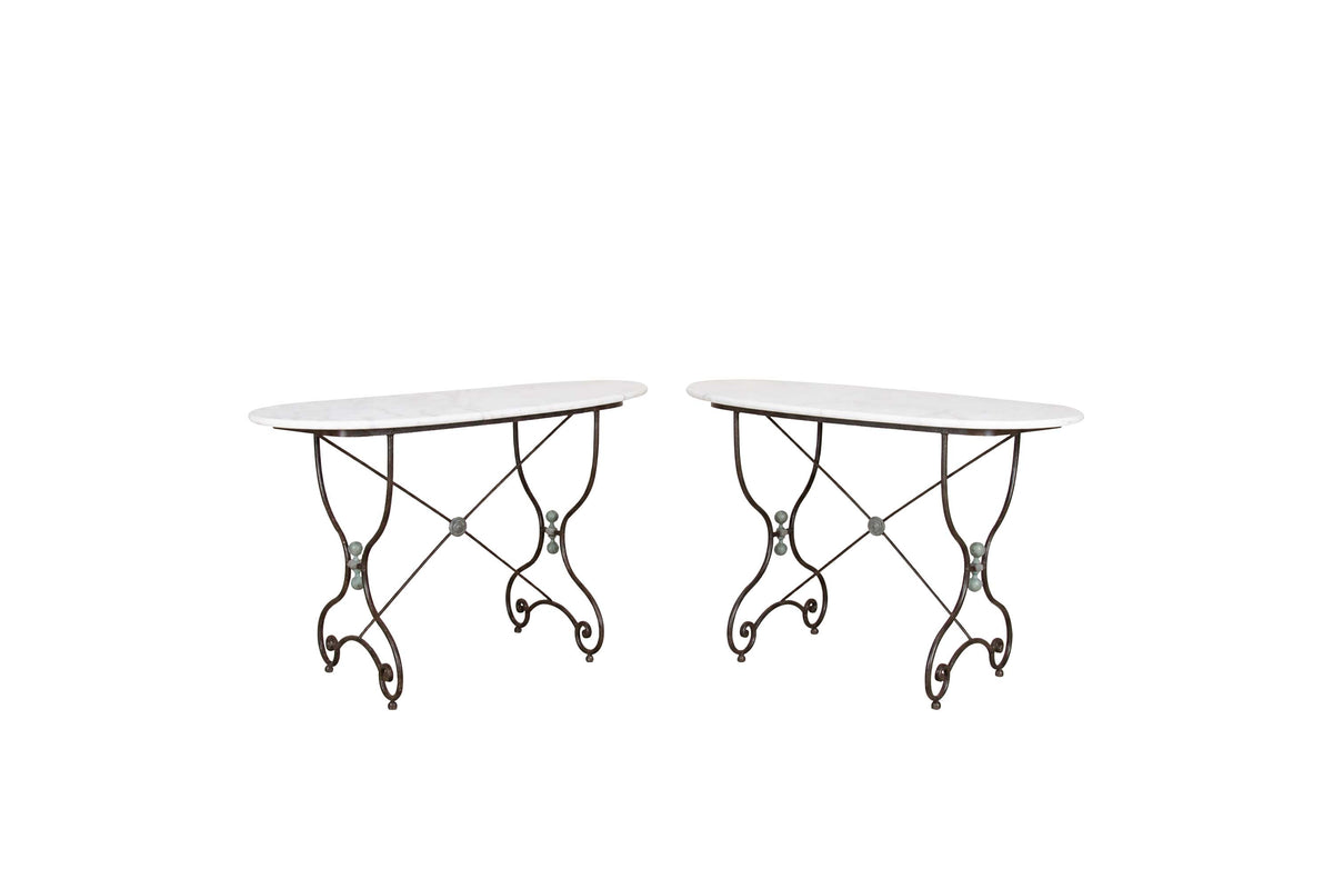 Beautiful, near pair of large 19th Century French iron tables with oval marble tops.