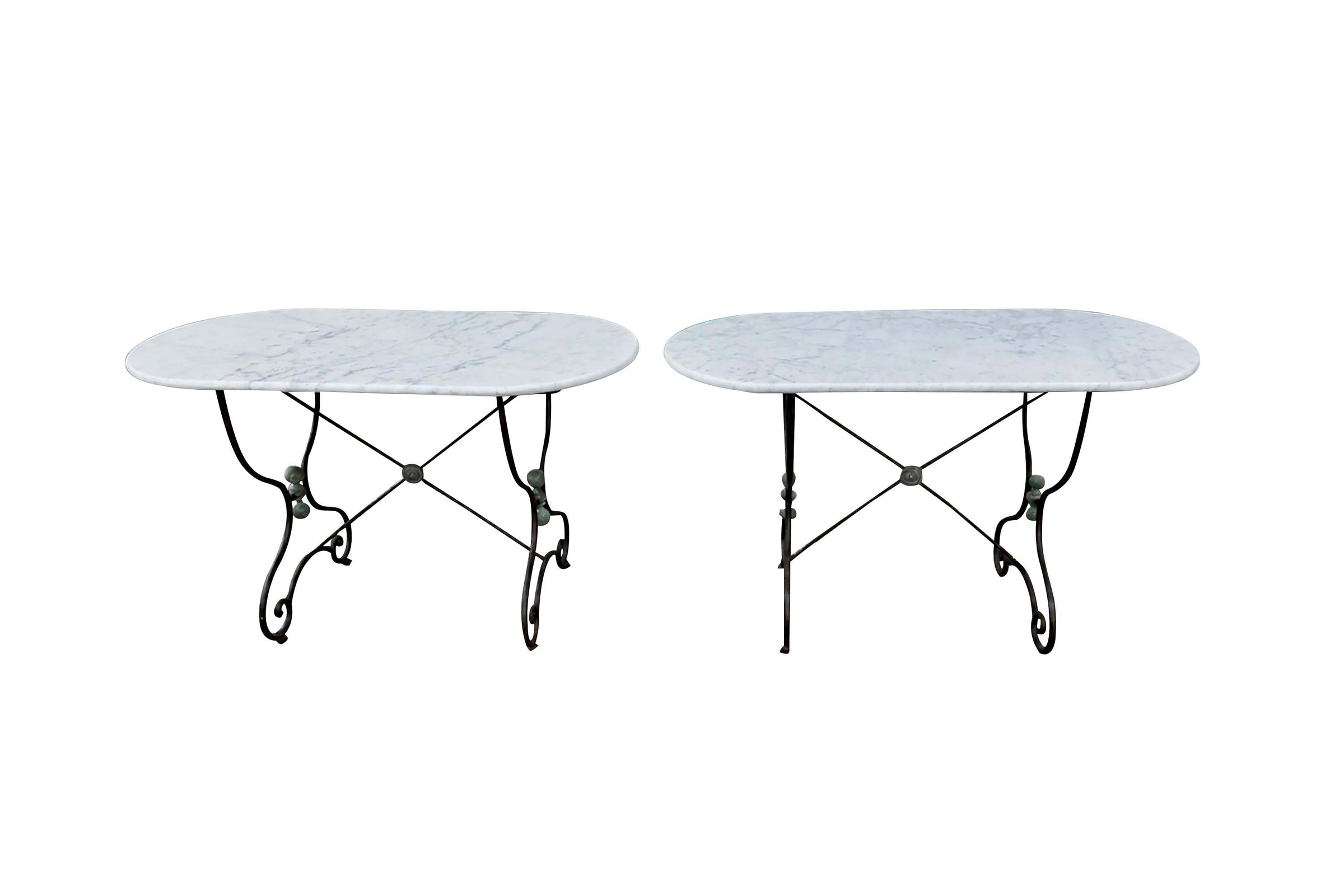Beautiful, near pair of large 19th Century French iron tables with oval marble tops.
