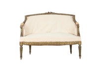 A refined petite 19th Century French sofa in the Louis XVI style.