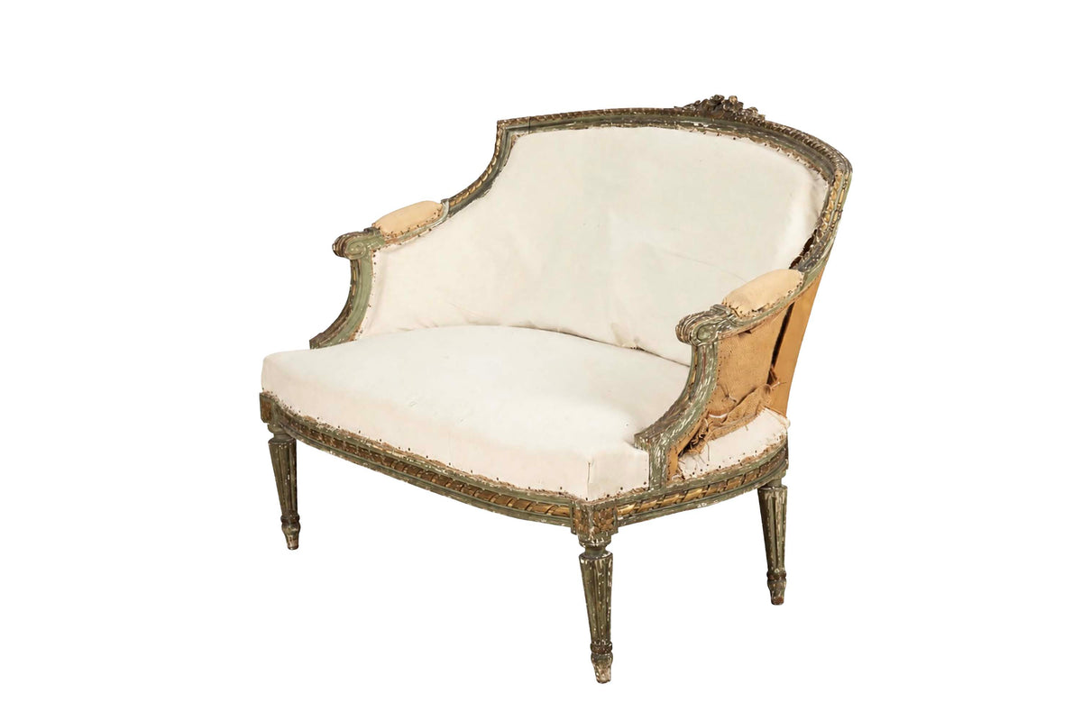 A refined petite 19th Century French sofa in the Louis XVI style.