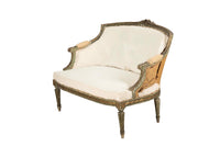 A refined petite 19th Century French sofa in the Louis XVI style.