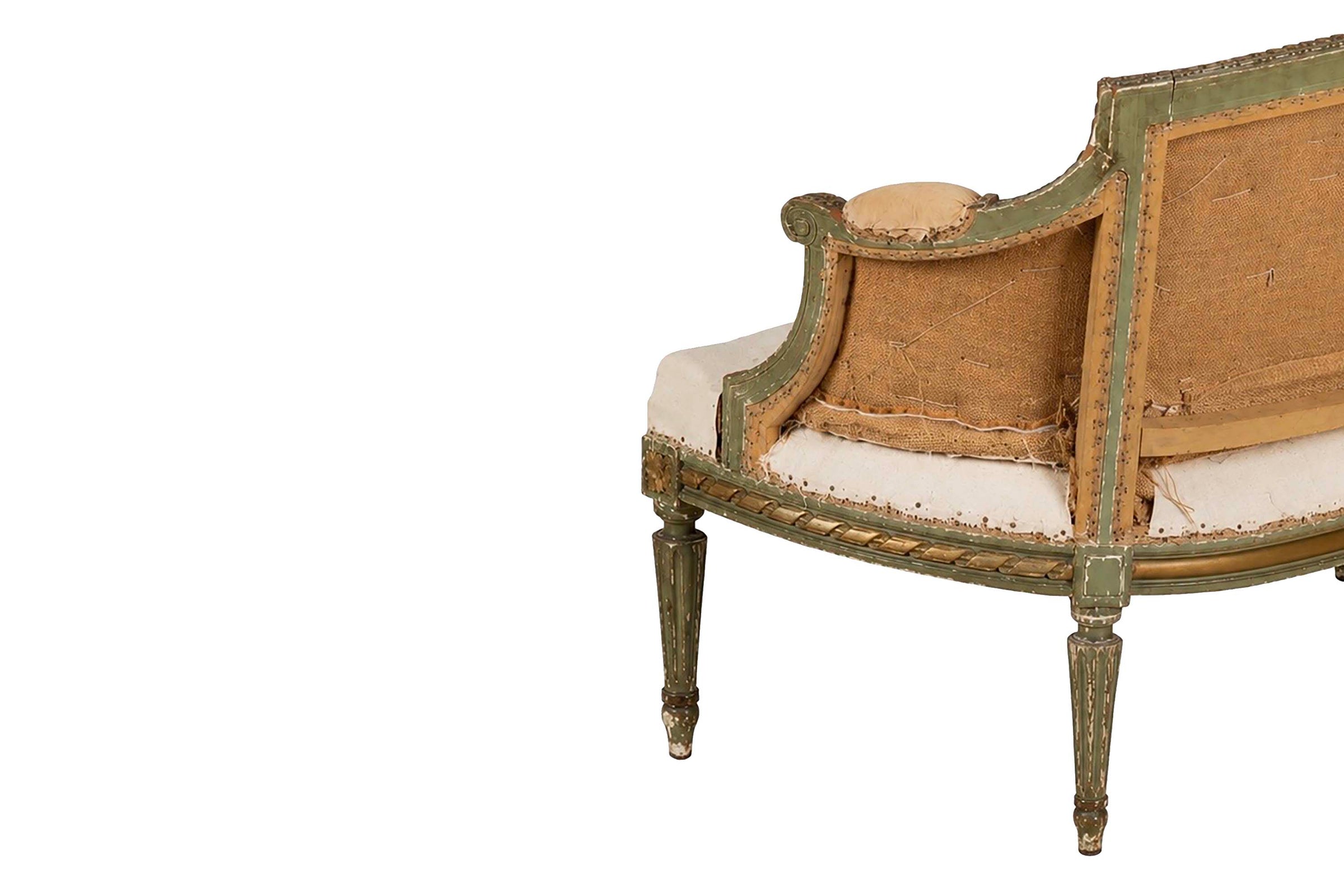 A refined petite 19th Century French sofa in the Louis XVI style.