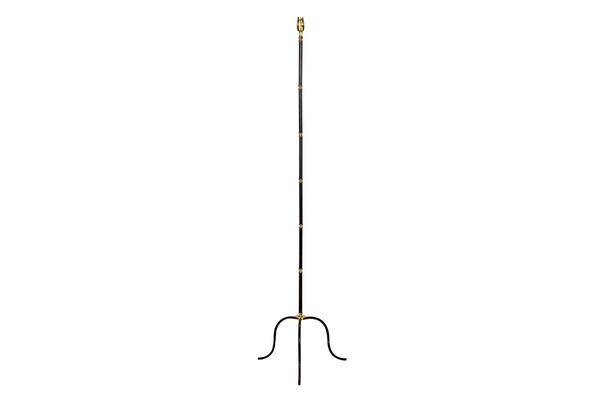 Mid-Century French black metal and brass floor lamp with elegant tripod base and restrained neoclassical styling.