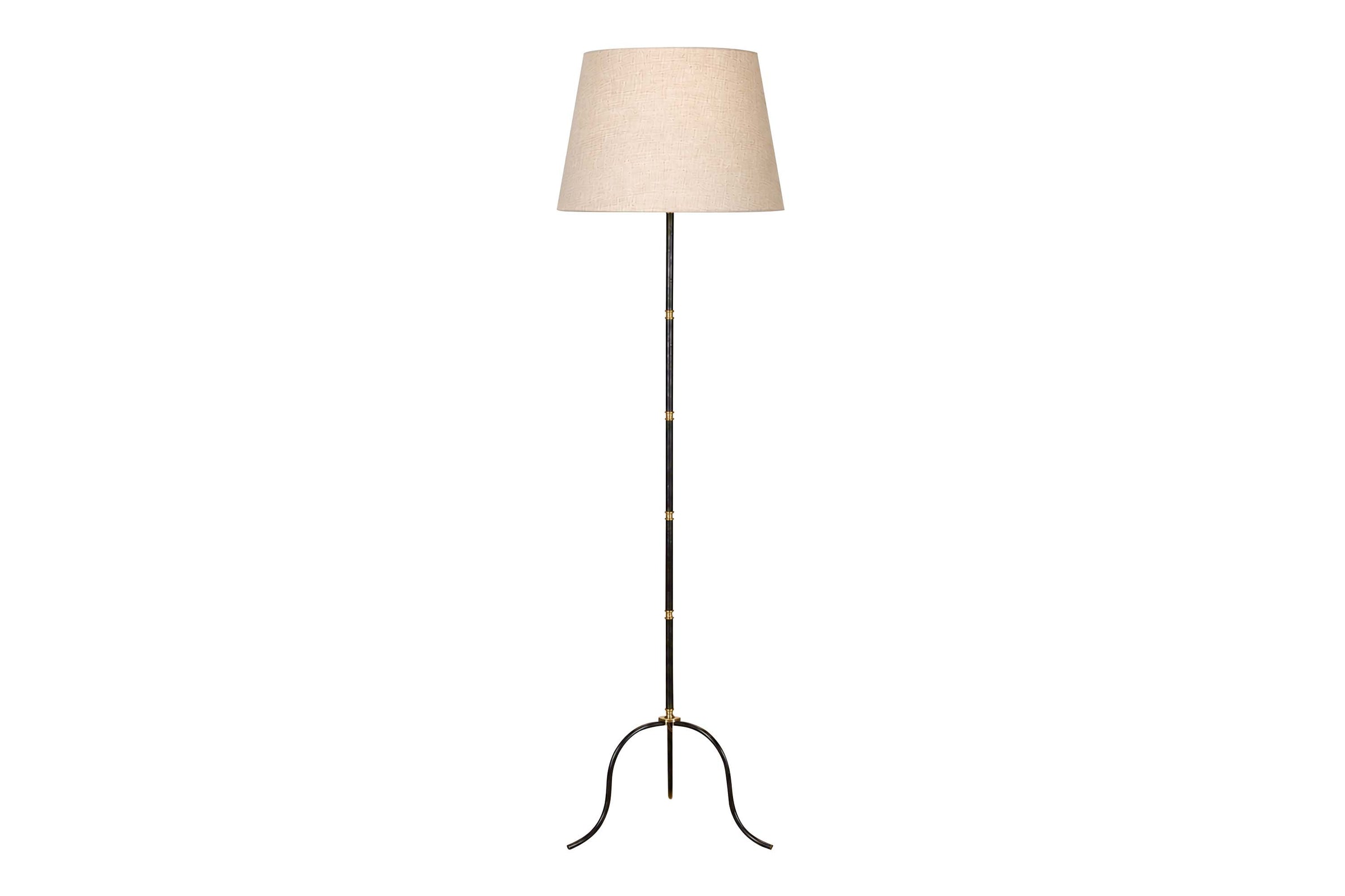 Mid-Century French black metal and brass floor lamp with elegant tripod base and restrained neoclassical styling.