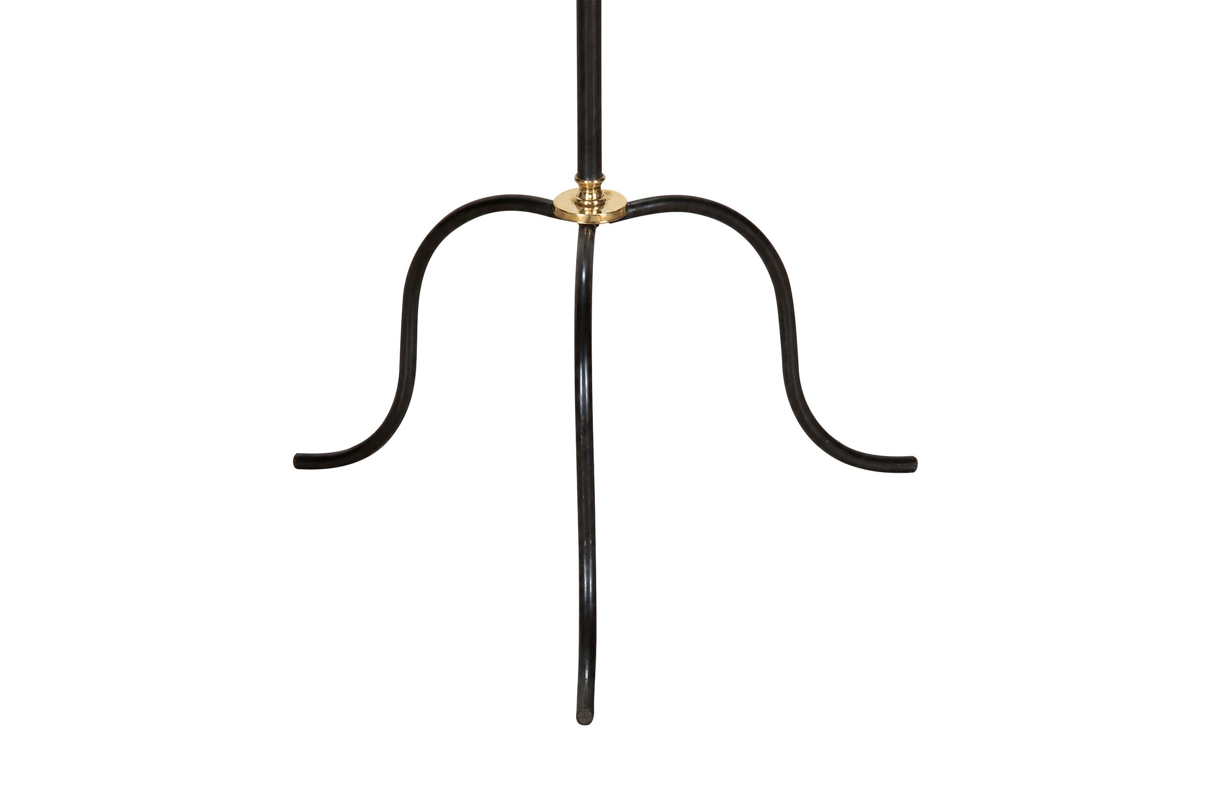 Mid-Century French black metal and brass floor lamp with elegant tripod base and restrained neoclassical styling.