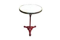 A charming late 19th Century French guéridon or café table, retaining its original cast iron tripod base with scrolling decoration and lovely classic cafe-red painted finish.