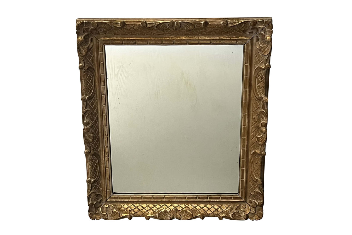 Early 20th Century French carved giltwood wall mirror of rectangular form.