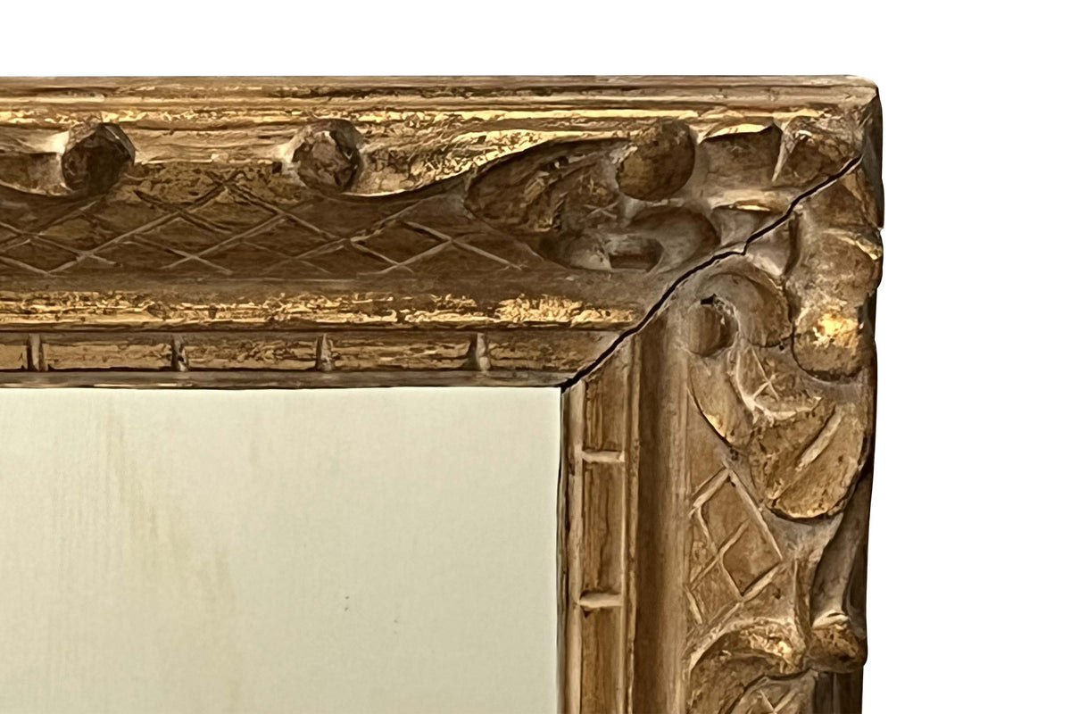 Early 20th Century French carved giltwood wall mirror of rectangular form.
