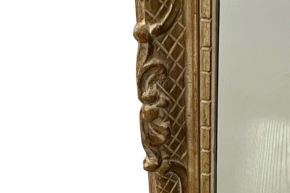 Early 20th Century French carved giltwood wall mirror of rectangular form.