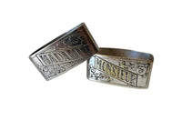 A charming pair of early 20th Century French silver-plated napkin rings engraved Madame and Monsieur. 