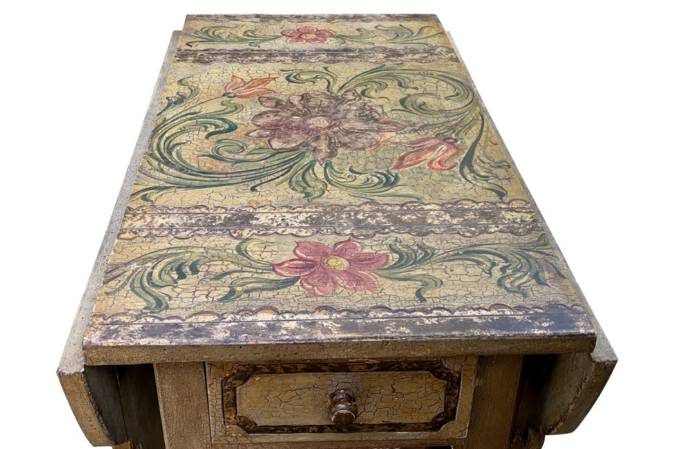 Antique table, painted, drop-leaf, Italian. hand-painted top decorated in scrolling foliate and floral motifs in warm ochre, green, lavender and terracotta tones.