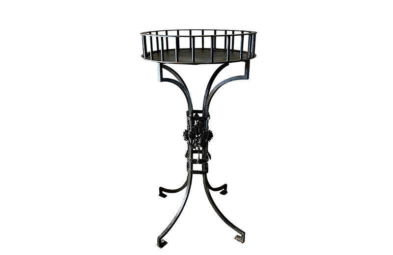 Tall black iron Art Deco plant stand in the manner of Edgar Brandt. Rose ornamentation to all sides of support. Circa 1930