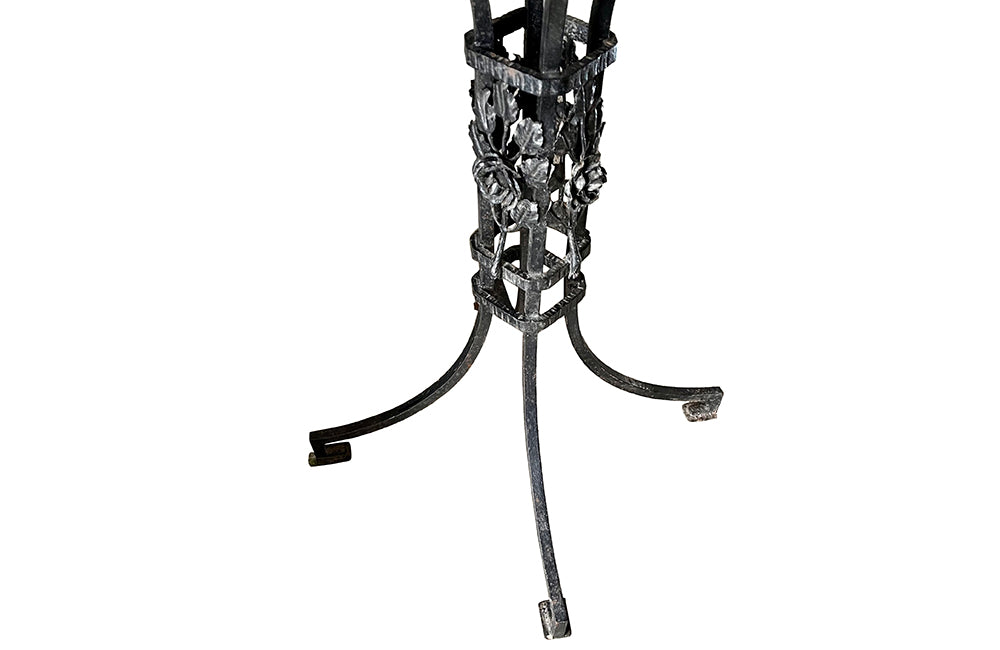 Tall black iron Art Deco plant stand in the manner of Edgar Brandt. Rose ornamentation to all sides of support. Circa 1930