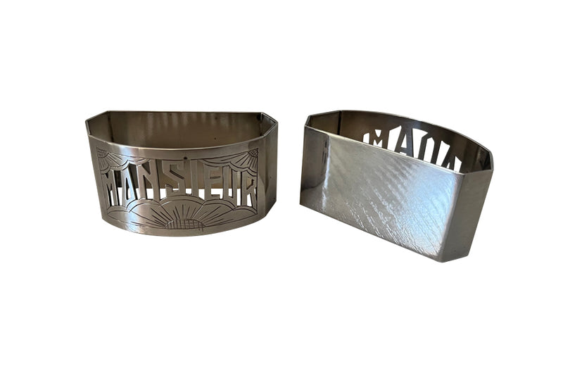 Very stylish Art Deco pair of silver plate napkin rings with cut out Madame and Monsieur lettering and stylised sun motifs.