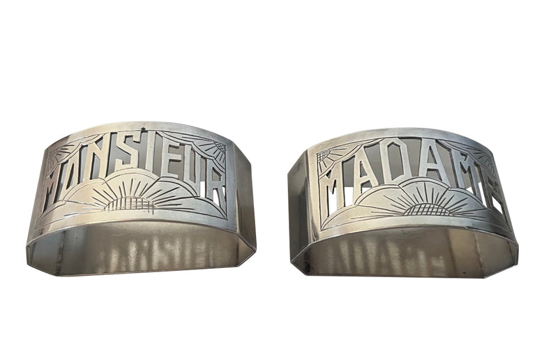 Very stylish Art Deco pair of silver plate napkin rings with cut out Madame and Monsieur lettering and stylised sun motifs.