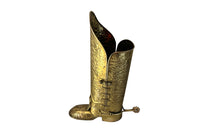 Decorative umbrella stand in the form of a large brass riding boot with brass laces to both sides, heel and spur.