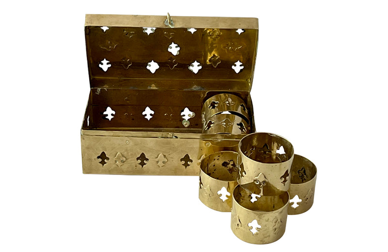 Mid-Century French lidded brass box with a set of six napkin rings