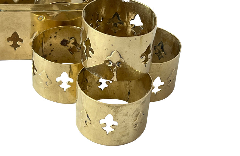 Mid-Century French lidded brass box with a set of six napkin rings