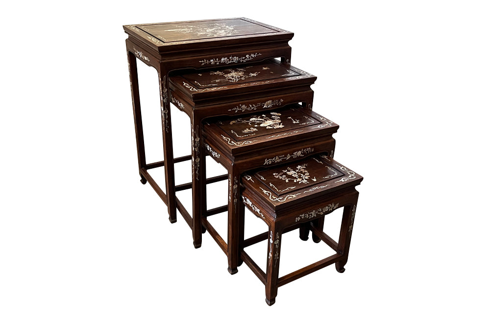 Nest of four Chinese  decorative teak occasional tables with inlaid mother of pearl inlay to the top and legs.