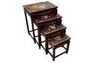 Nest of four Chinese  decorative teak occasional tables with inlaid mother of pearl inlay to the top and legs.