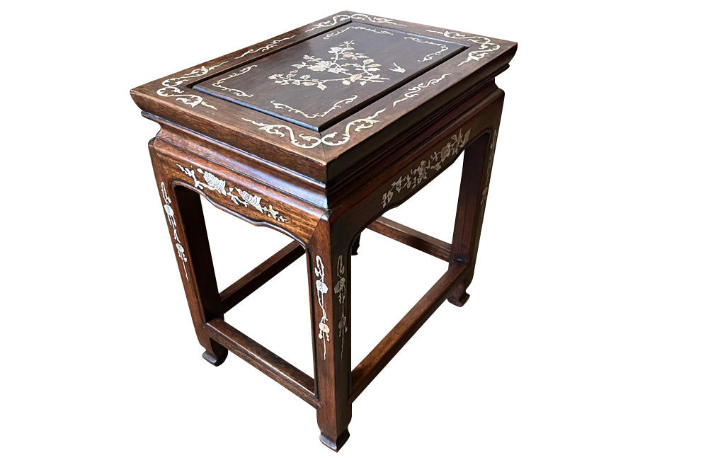 Nest of four Chinese  decorative teak occasional tables with inlaid mother of pearl inlay to the top and legs.