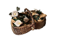 COLLECTION OF 29 CERAMIC FLOWERS IN A HARVEST BASKET