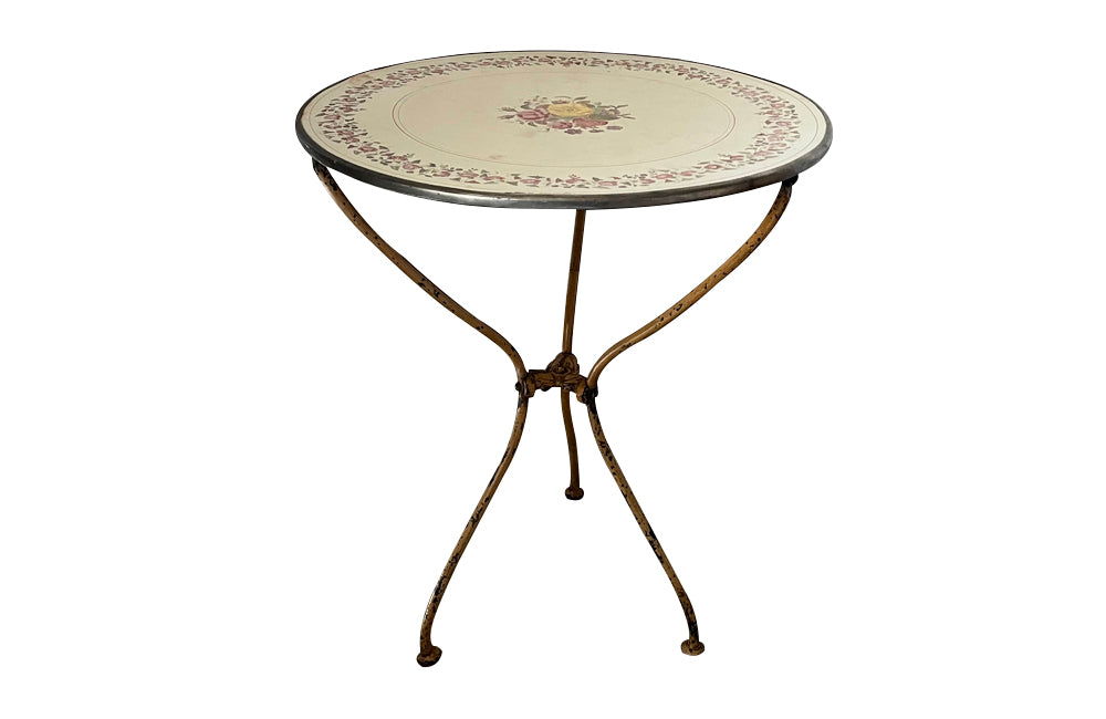 Rare, French enamel top gueridon
table with painted iron tripod base joined with central floral medaillion and
pretty enamelled top with floral motifs