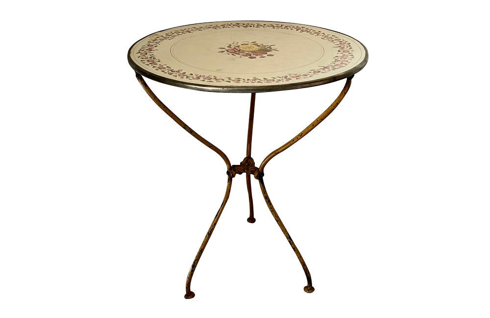 Rare, French enamel top gueridon
table with painted iron tripod base joined with central floral medaillion and
pretty enamelled top with floral motifs