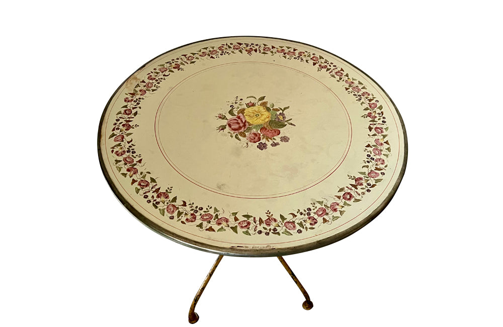 Rare, French enamel top gueridon
table with painted iron tripod base joined with central floral medaillion and
pretty enamelled top with floral motifs