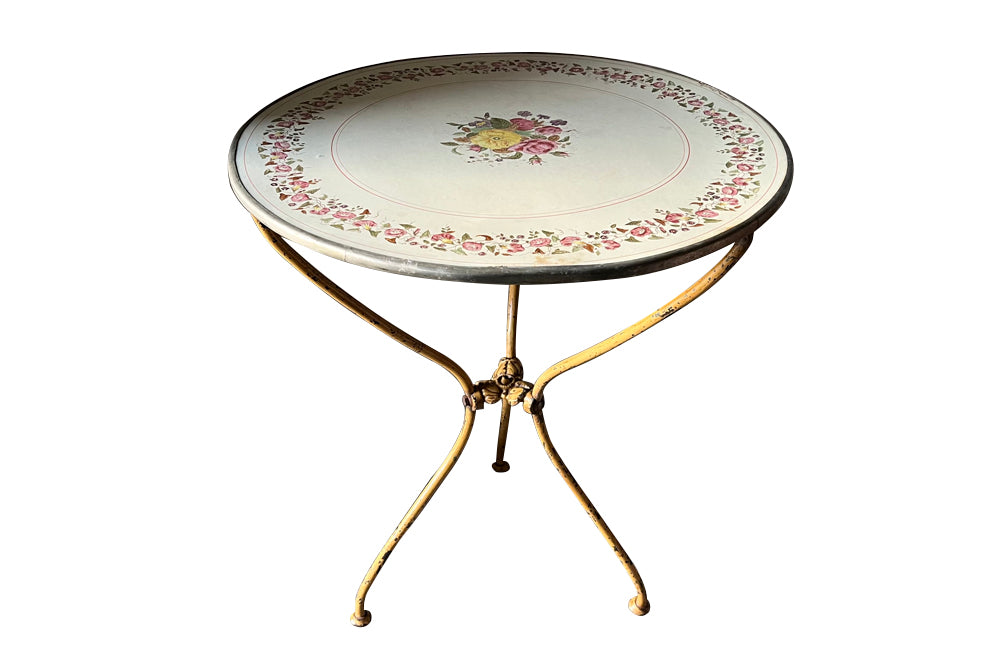 Rare, French enamel top gueridon
table with painted iron tripod base joined with central floral medaillion and
pretty enamelled top with floral motifs