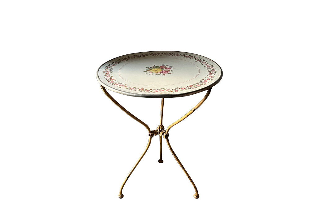 Rare, French enamel top gueridon
table with painted iron tripod base joined with central floral medaillion and
pretty enamelled top with floral motifs