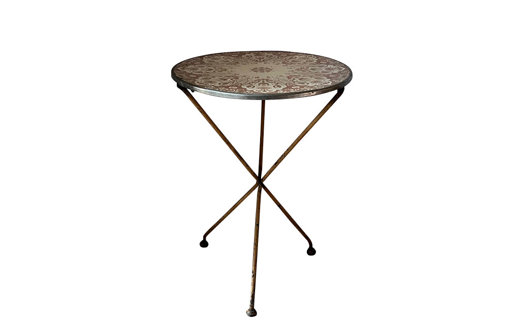 Rare, early 20th century French enamel top gueridon bistro table with iron tripod base and enamelled top featuring floral and foliate motifs.