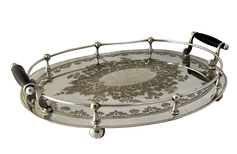 Elegant, silver plate tray with raised gallery and ebony handles engraved with floral and foliate decoration and empty central cartouche bearing the makers mark of Mackay Bros, Dundee.