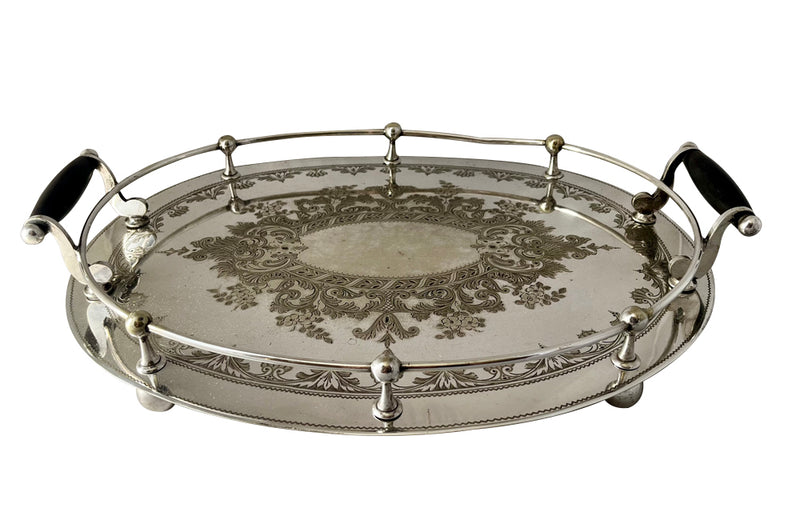 Elegant, silver plate tray with raised gallery and ebony handles engraved with floral and foliate decoration and empty central cartouche bearing the makers mark of Mackay Bros, Dundee.