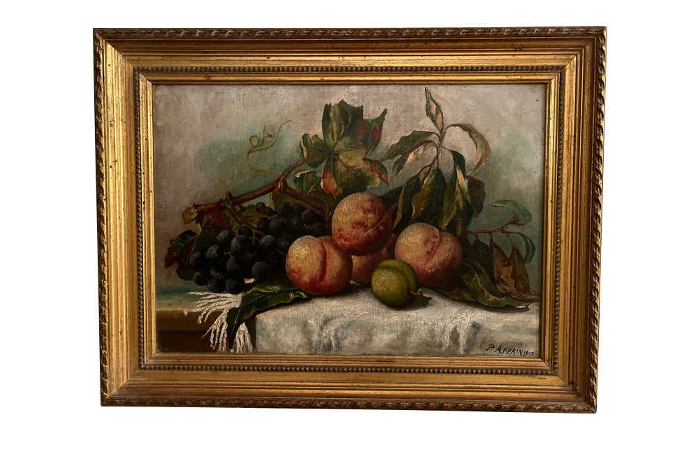 20th Century French framed still life painting of peaches and grapes on a draped fringed table cloth.
