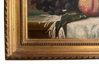 20th Century French framed still life painting of peaches and grapes on a draped fringed table cloth.