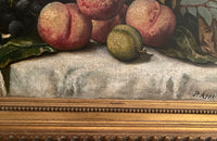 20th Century French framed still life painting of peaches and grapes on a draped fringed table cloth.