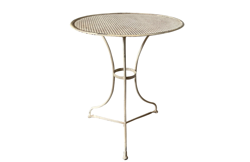 French iron garden table with pierced round top on tripod base with circular stretcher circa 1900