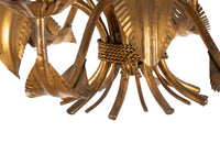 Large mid 20th century gilt metal chandelier with palm fronds surrounding a central ringed stem in the manner of Maison Jansen.