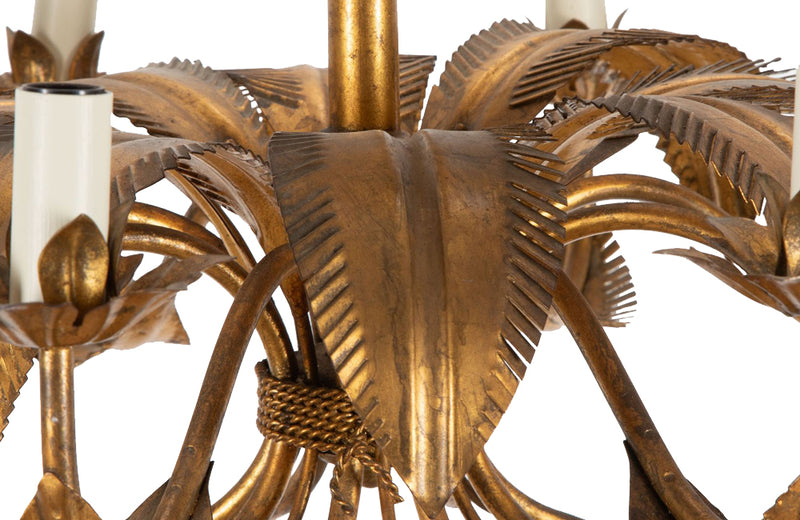 Large mid 20th century gilt metal chandelier with palm fronds surrounding a central ringed stem in the manner of Maison Jansen.