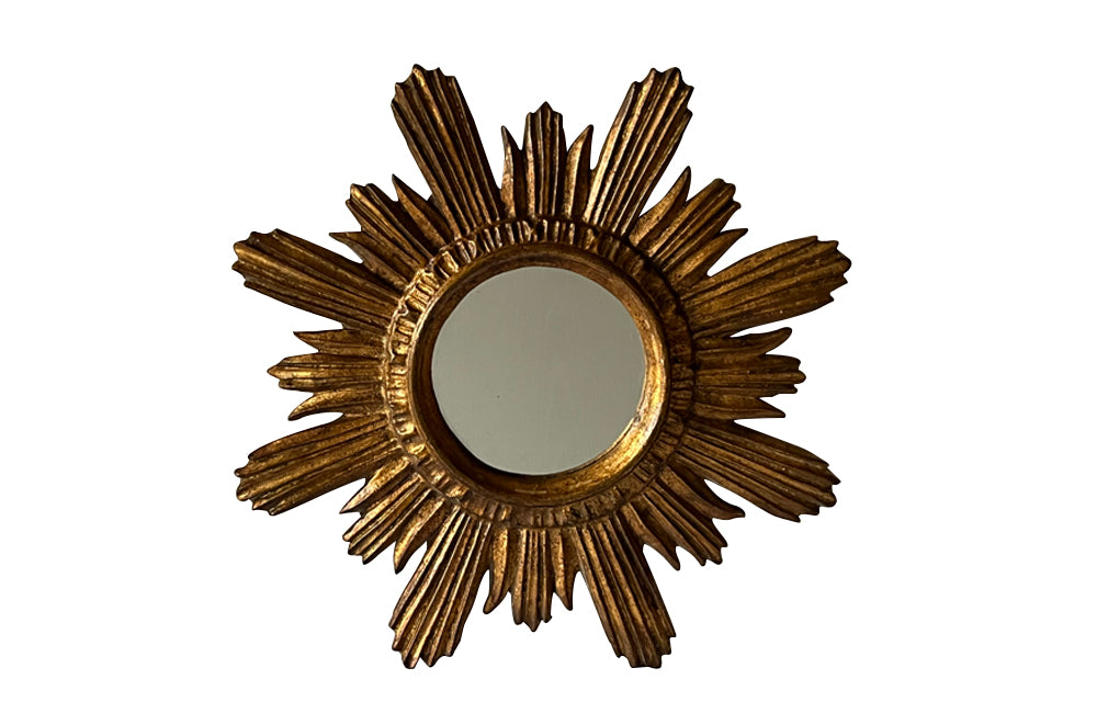 Mid 20th Century decorative Spanish giltwood sunburst mirror with rays. 