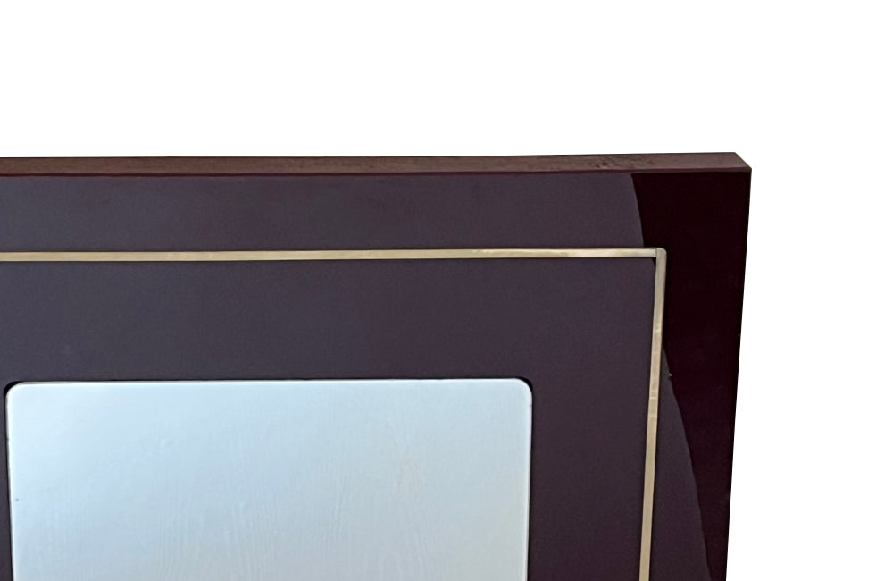 1970s mirror with burgundy acrylic frame and brass banding. Italian