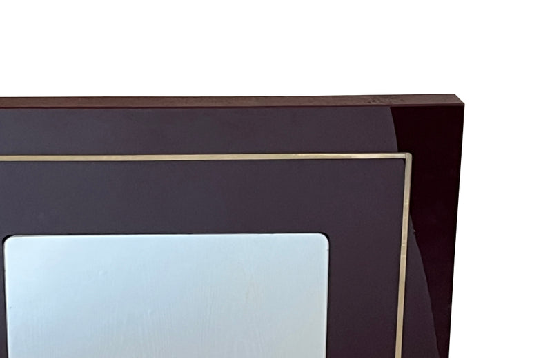1970s mirror with burgundy acrylic frame and brass banding. Italian