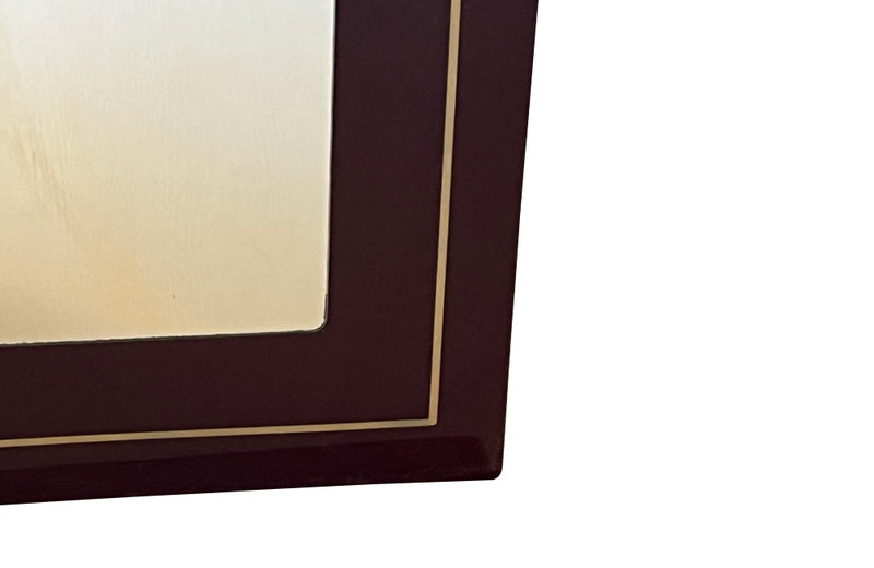 1970s mirror with burgundy acrylic frame and brass banding. Italian
