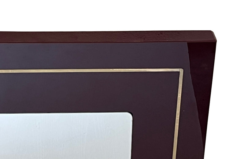 1970s mirror with burgundy acrylic frame and brass banding. Italian