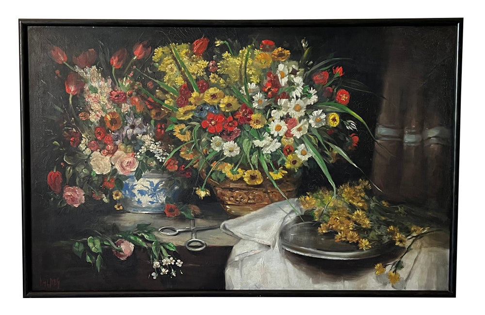 19th Century still life painting of flowers in a florist setting with draped table and backdrop.  This joyous oil on canvas has been beautifully relined and framed in a simple black frame. It is signed Valdeg - AD & PS Antiques